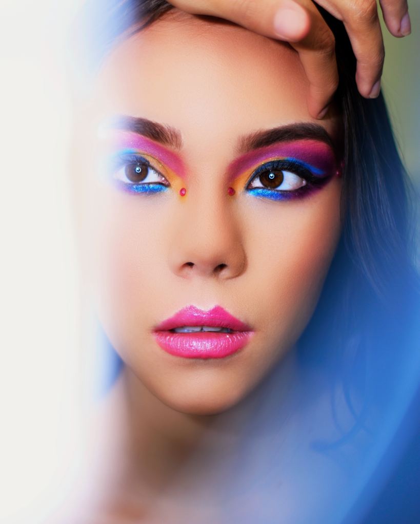 photo of a woman wearing bright eye and lip makeup
